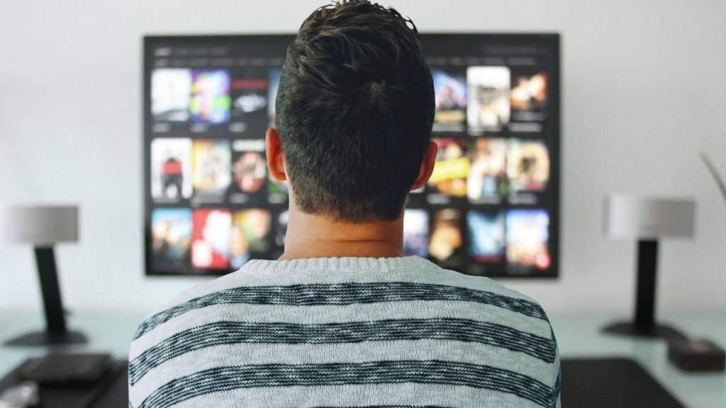 Man Watching TV in His Home Office